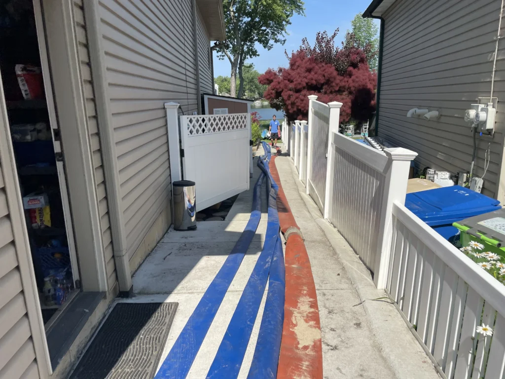 sand and water hoses running alongside the home.