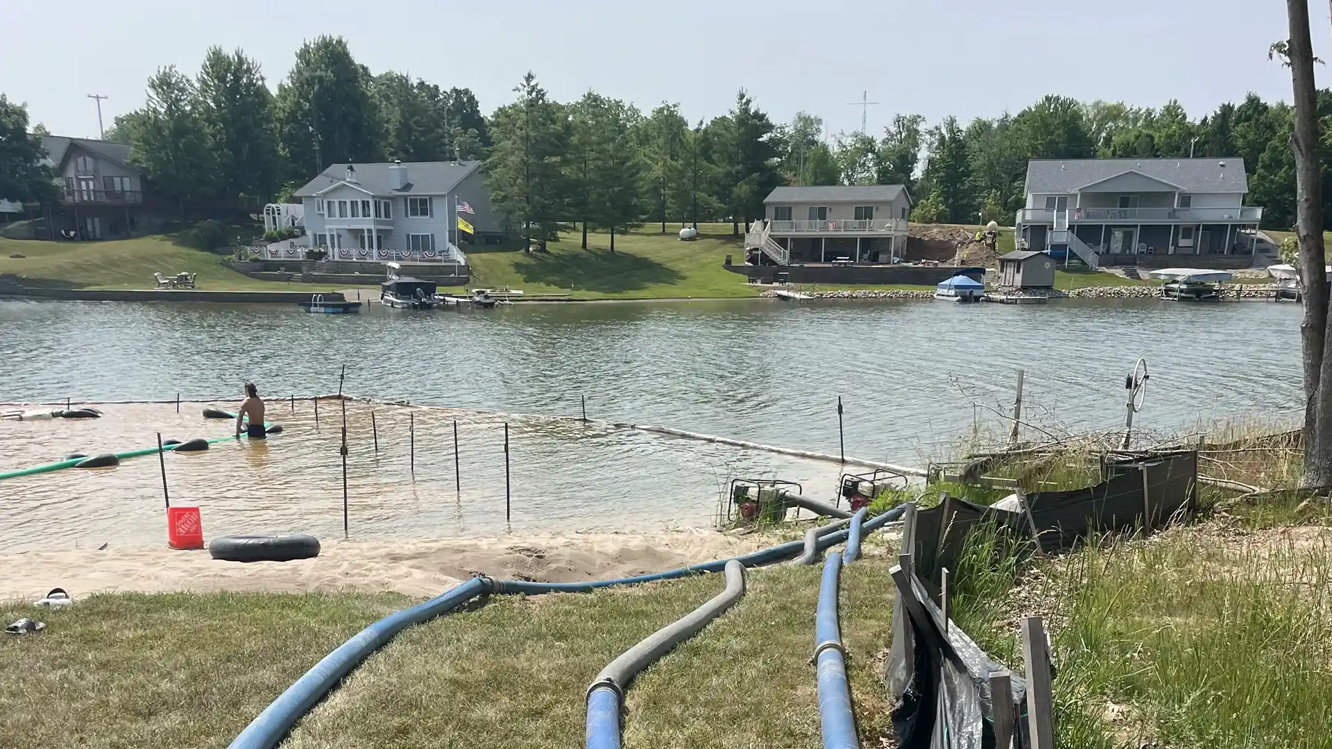 installing beach sand onto a new beach on Lake Diane in Camden, MI.