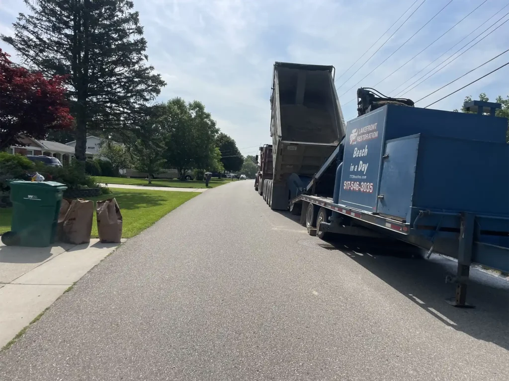 The Sand Pro system parked along side the street getting ready to add sand to a Long Lake beach in Oxford Michigan.